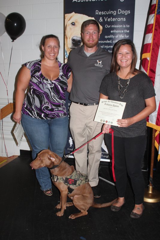 Semper K9's Casey with her handler, Executive Director Christopher Baity and her Operation Paws for Homes Foster Stephanie. 